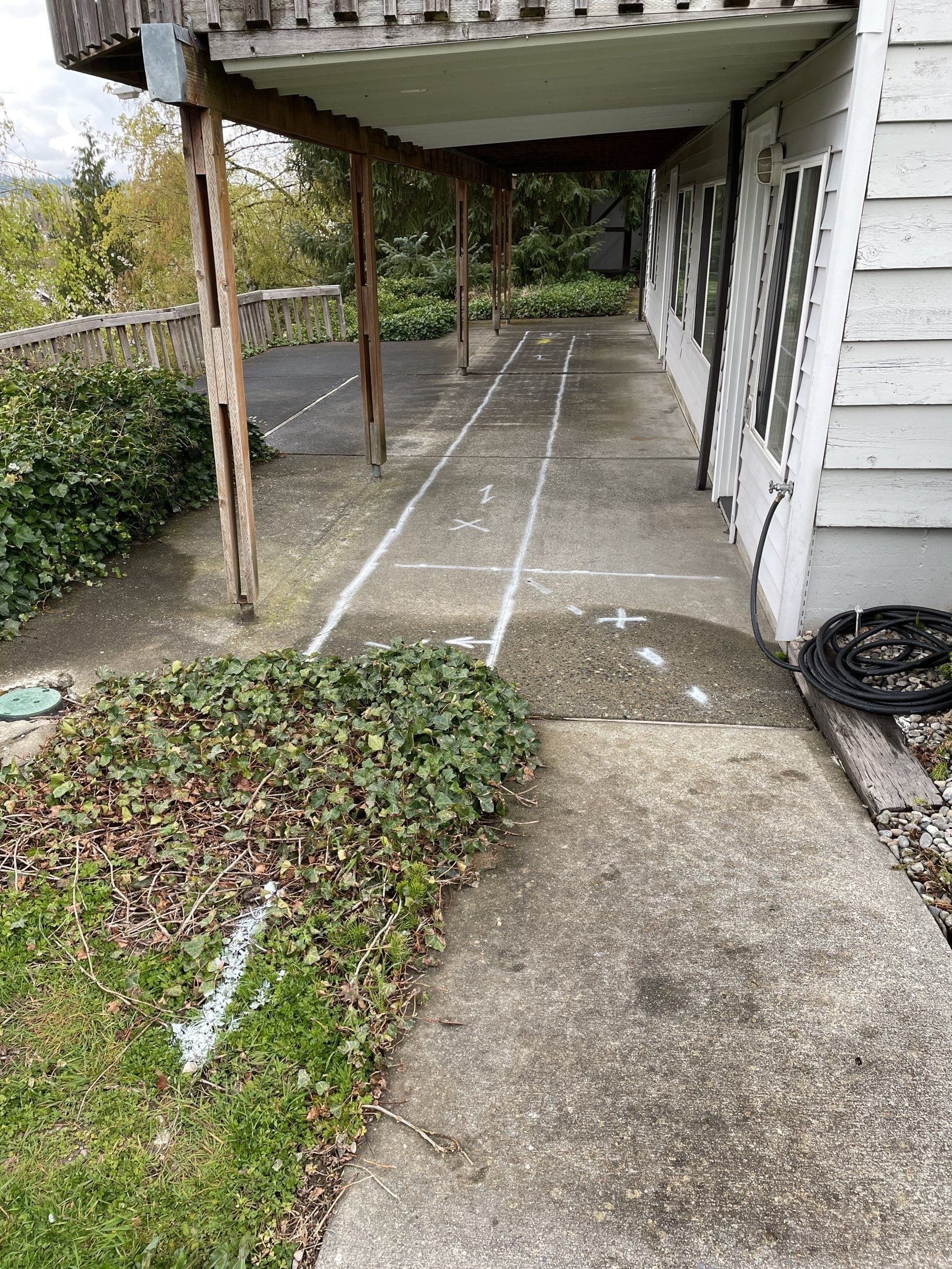 Marking the new sewer location with white paint under the deck.